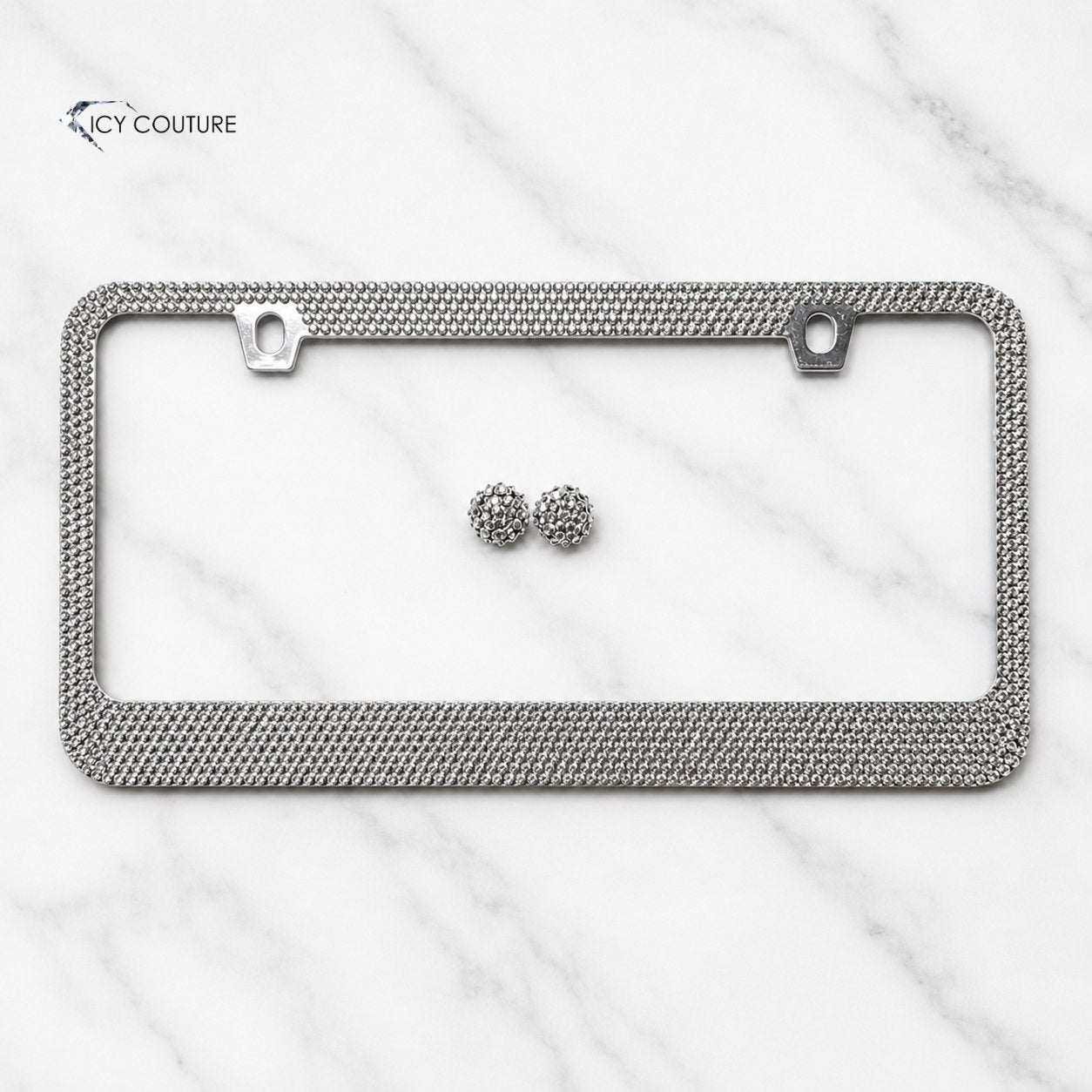 A silver license plate frame covered in Chrome rhinestones with two matching screw caps premade crystal frame by ICY Couture