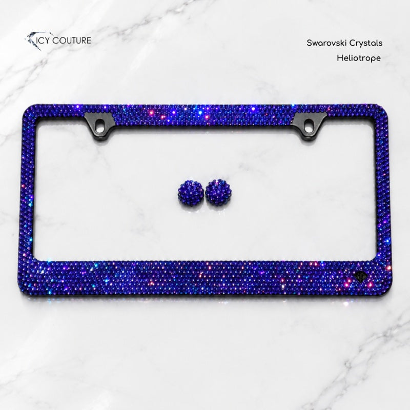Crystal license plate frames by ICY Couture showing Jet Black and Jet Hematite rhinestone finishes, hand-crystallized luxury bling car accessories on white marble.