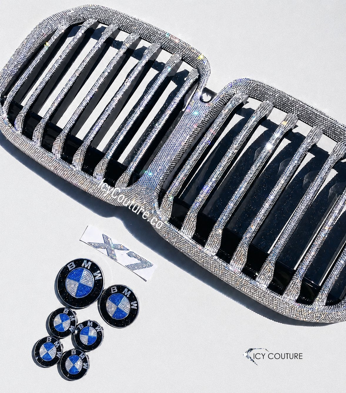 Fully crystallized BMW X7 Grille with matching BMW front and back replacement emblems, matching crystal center caps crystallized with Swarovski Crystals by ICY Couture for new car owners luxury car makeover.