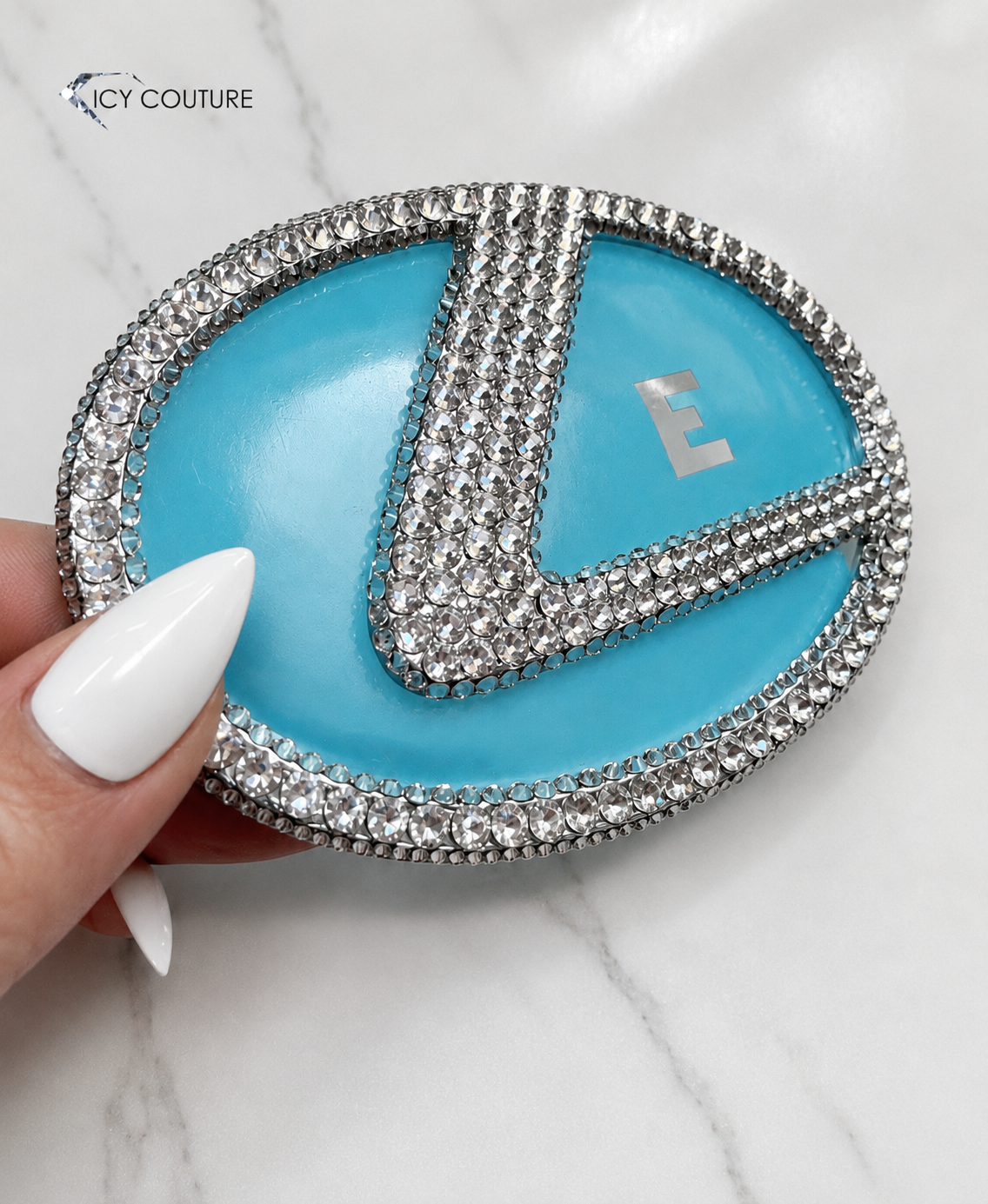 Custom crystal car emblem by ICY Couture featuring a Lexus emblem hand-crystallized with Diamond Clear Swarovski Crystals for luxury automotive customization.