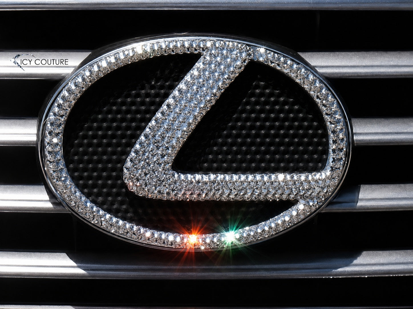 Custom crystal Lexus grille emblem by ICY Couture with Diamond Clear Swarovski Crystals on a black grille for luxury car emblem customization.