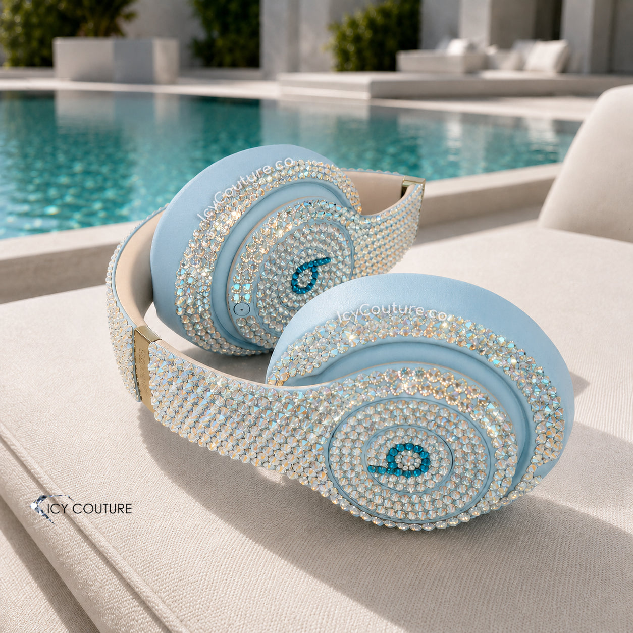 Crystal Headphones Customized with Swarovski Crystals laying on a luxury pool bench personalized gifts by ICY Couture.