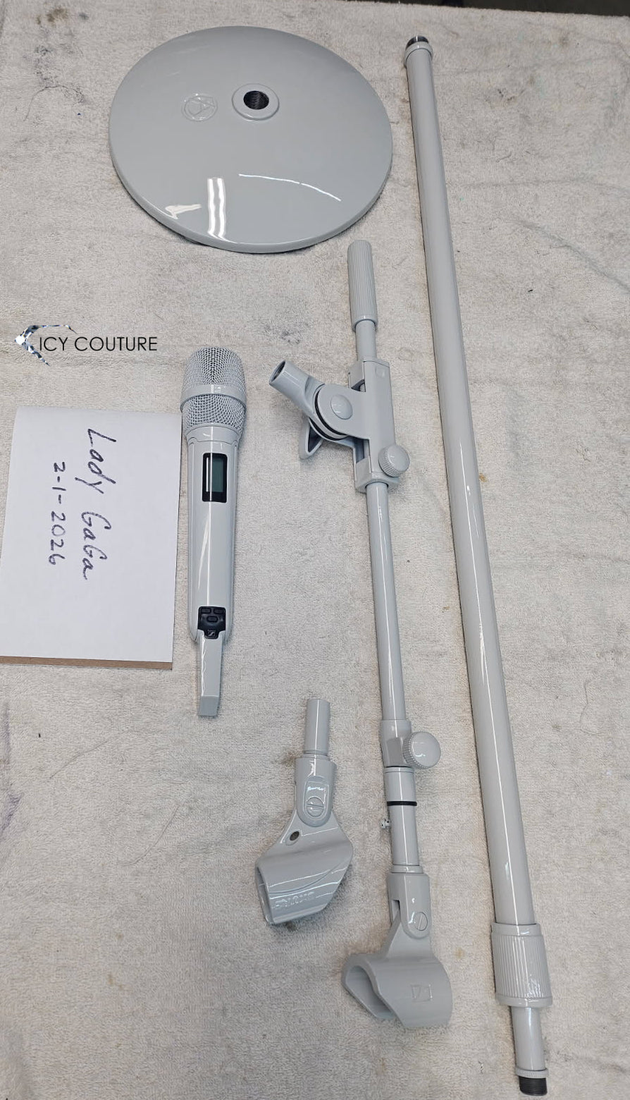 Behind the scenes disassembled white microphone and mic stand after custom coating service for Lady Gaga by ICY Couture.
