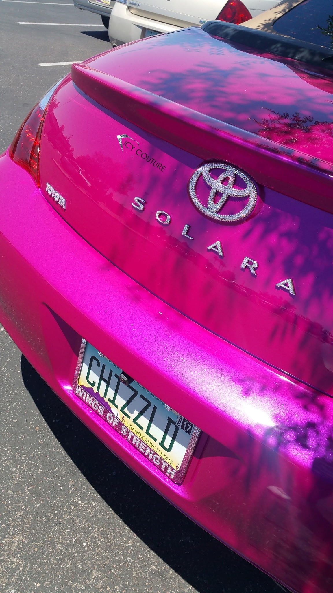 Close-up rear view on a hot pink Toyota Solara car, showing installed ICY Couture  trunk badge, Solara and Toyota letters with custom name rhinestone license plate frame hand-crystallized for a customer. 