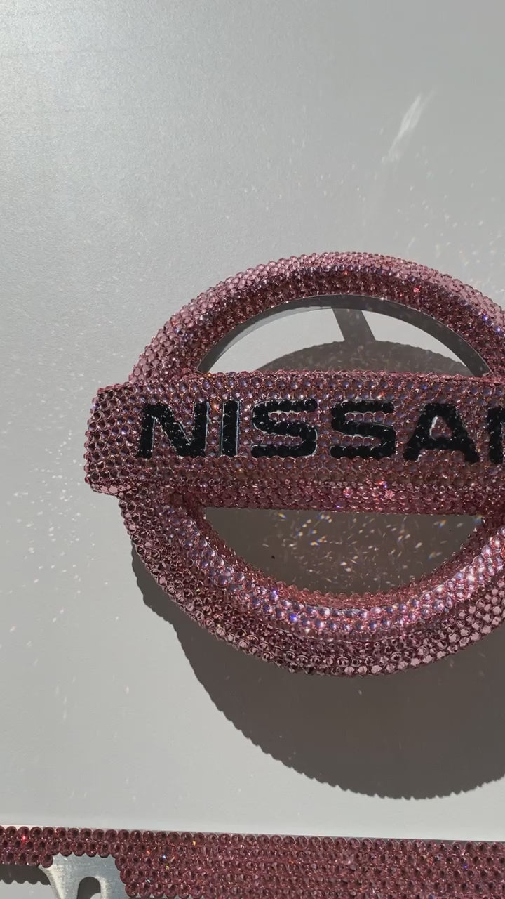 Video of Pink Bling Nissan Emblems with Matching License Plate Frame bedazzled with Rose Pink Premium Glass Rhinestones