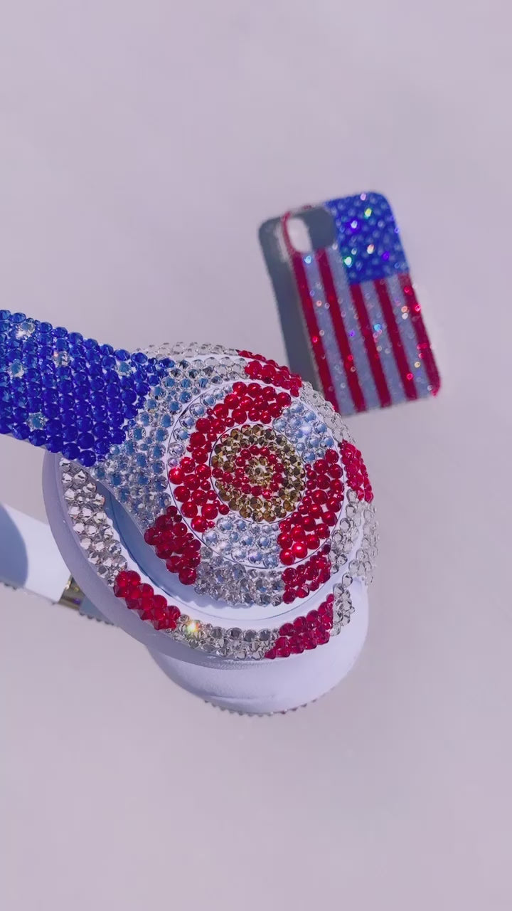 Video of American Flag set: Bling iPhone 15 Cover with Matching Bling Studio Beats Headphones Custom Bedazzled with Swarovski crystals or premium glass rhinestones by ICY Couture.