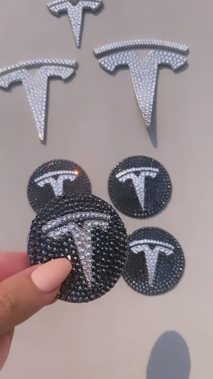 Watch video of gorgeous crystal Tesla emblems set that includes front. back and steering wheel emblems and matching crystal Tesla center wheel rim caps, crystallized by ICY Couture.