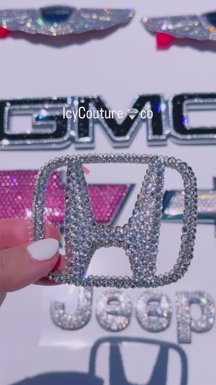 Video of Icy Couture car emblems include Honda, GMC, Chevy, Jeep emblems, bedazzled with Swarovski crystals