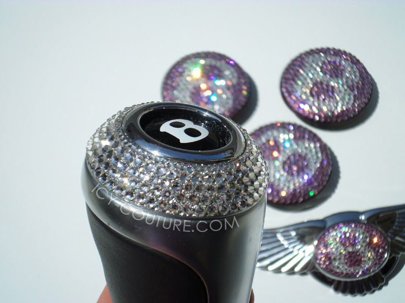 Custom crystal Bentley gear shift knob by ICY Couture with Diamond Clear Swarovski Crystals and matching iridescent crystal car emblems for luxury car interior customization.